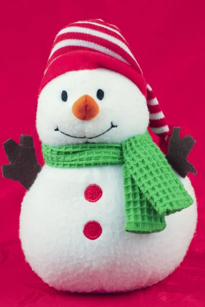 Speelgoed sneeuwpop op rood — Stockfoto