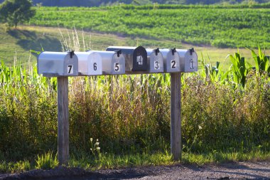 Seven mail boxes on a country road clipart