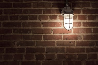 Creepy light on textrued brick wall clipart