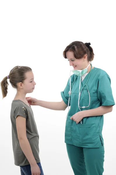 Doctor treating schoolgirl — Stock Photo, Image
