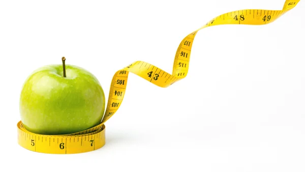 Yeşil elma ve santimetre bırakarak — Stok fotoğraf