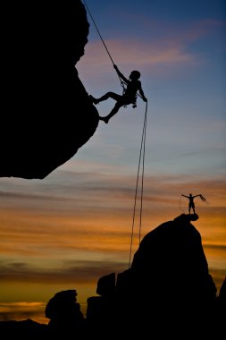 Climber rappelling. clipart