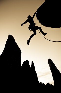 Climber clinging to the edge. clipart