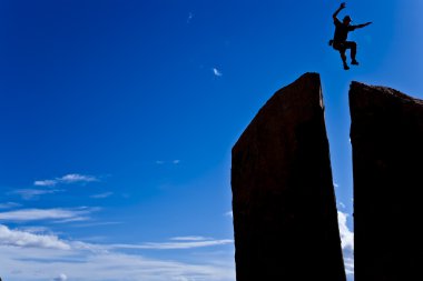 Rock climber on the summit. clipart