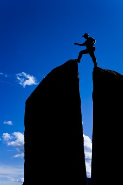 Rock climber on the summit. clipart