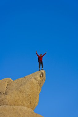 Climber on the summit. clipart