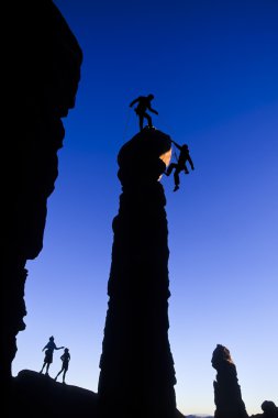 Team of climbers on the summit. clipart