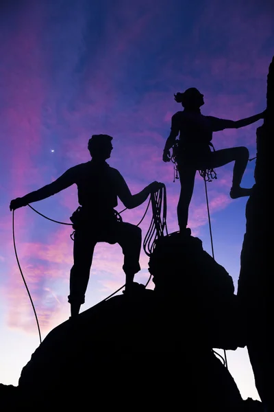 stock image Team of climbers reaching the summit.