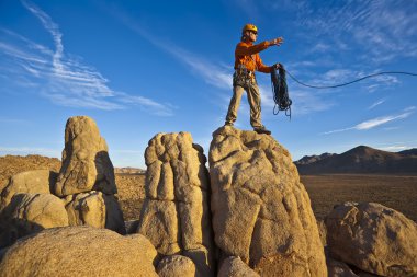 Rock climber on the summit. clipart