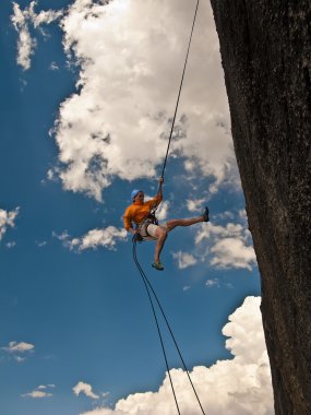 Climber rappelling. clipart