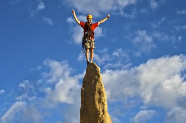 Climber on the summit. clipart