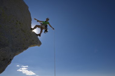 Climber rappelling. clipart