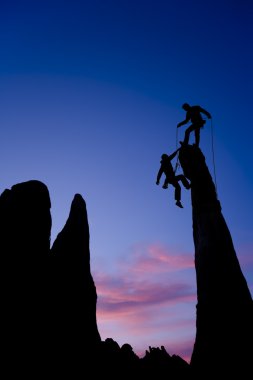 Team of climbers on the summit. clipart