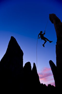 Climber rappelling. clipart