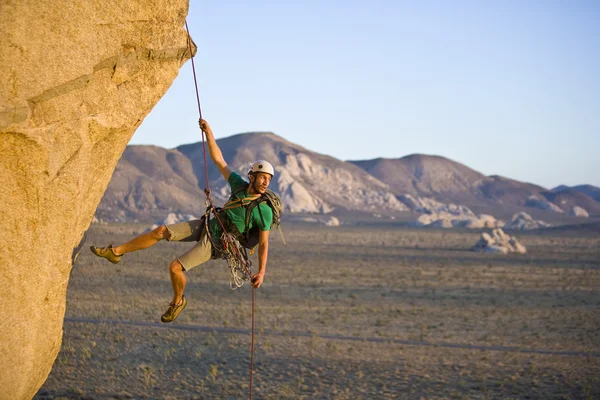 Rock climber rappelling. — Stock Photo, Image