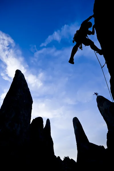 Climber ascending a rock spire — Stock Photo, Image