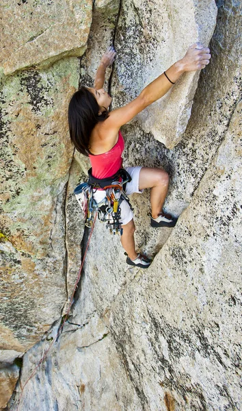 Θηλυκό ορειβάτης σκαρφαλωμένο σε ένα βράχο. — Φωτογραφία Αρχείου
