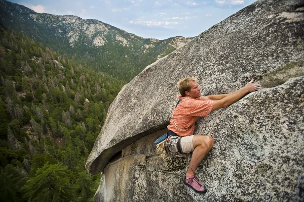 Szikla mászó kapaszkodva egy szikláról. — Stock Fotó
