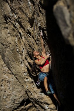 Female rock climber. clipart
