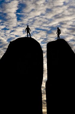 Team of climbers reaching the summit. clipart