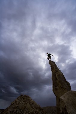 Male rock climber in Joshua Tree National Park, CA. clipart