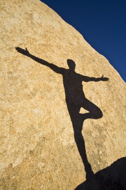 A man practices Yoga. clipart