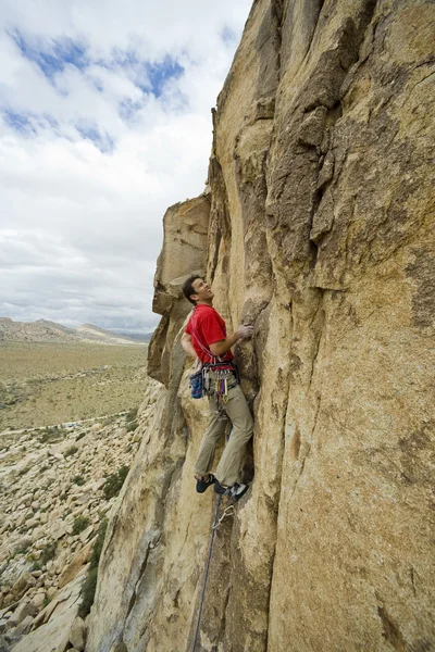 Klimmer klampt zich vast aan een klif. — Stockfoto