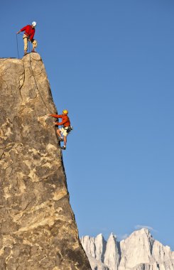 Rock climber rappelling. clipart