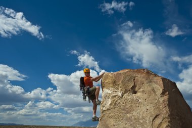 Rock climber nearing the summit. clipart