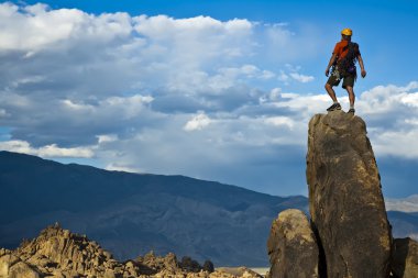 Rock climber nearing the summit. clipart