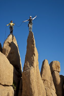 Team of climbers reaching the summit. clipart