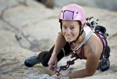 Female rock climber. clipart