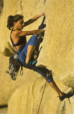 Female rock climber. clipart