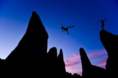 Climber on a tyrolean traverse. clipart