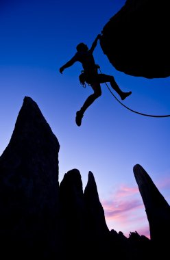 Climber clinging to the edge. clipart