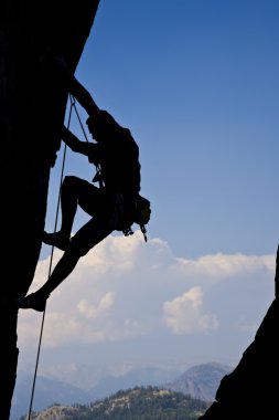 Rock climbing an overhanging face. clipart