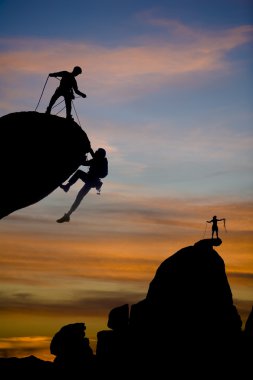 Team of climbers on the summit. clipart