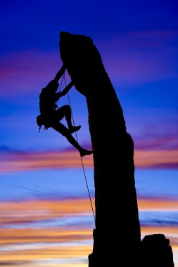 Rock climber silhouetted. clipart