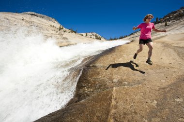 Hiker running near cascades. clipart