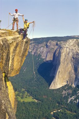 Team of climbers on the summit. clipart