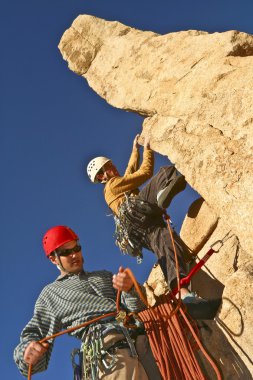 Team of rock climbers. clipart