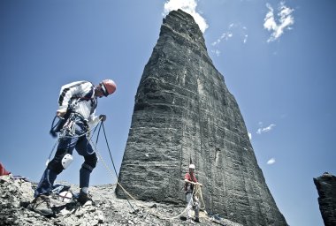 Team of climbers reaching the summit. clipart