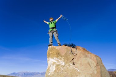 Climber on the summit. clipart