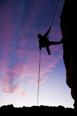 Climber rappelling. clipart