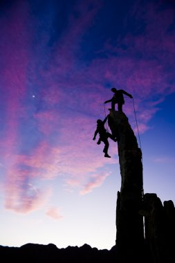 Team of climbers on the summit. clipart