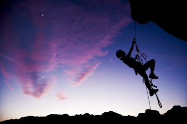 Climber rappelling. clipart