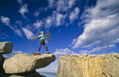 Rock climber on the summit. clipart