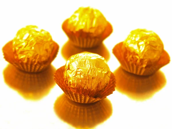 Candy in gold wrappers — Stock Photo, Image