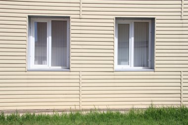 Wall of the house, lined with vinyl siding clipart