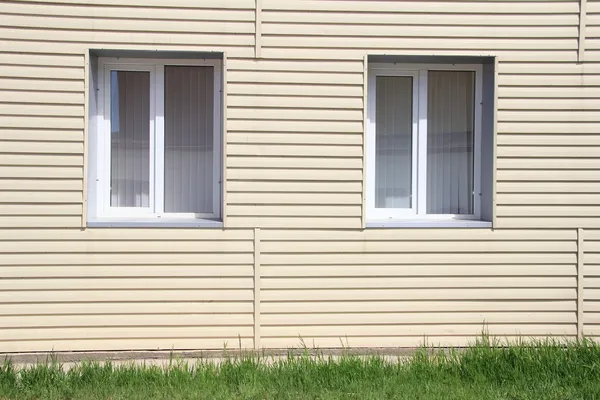 Wall of the house, lined with vinyl siding — Stock Photo, Image